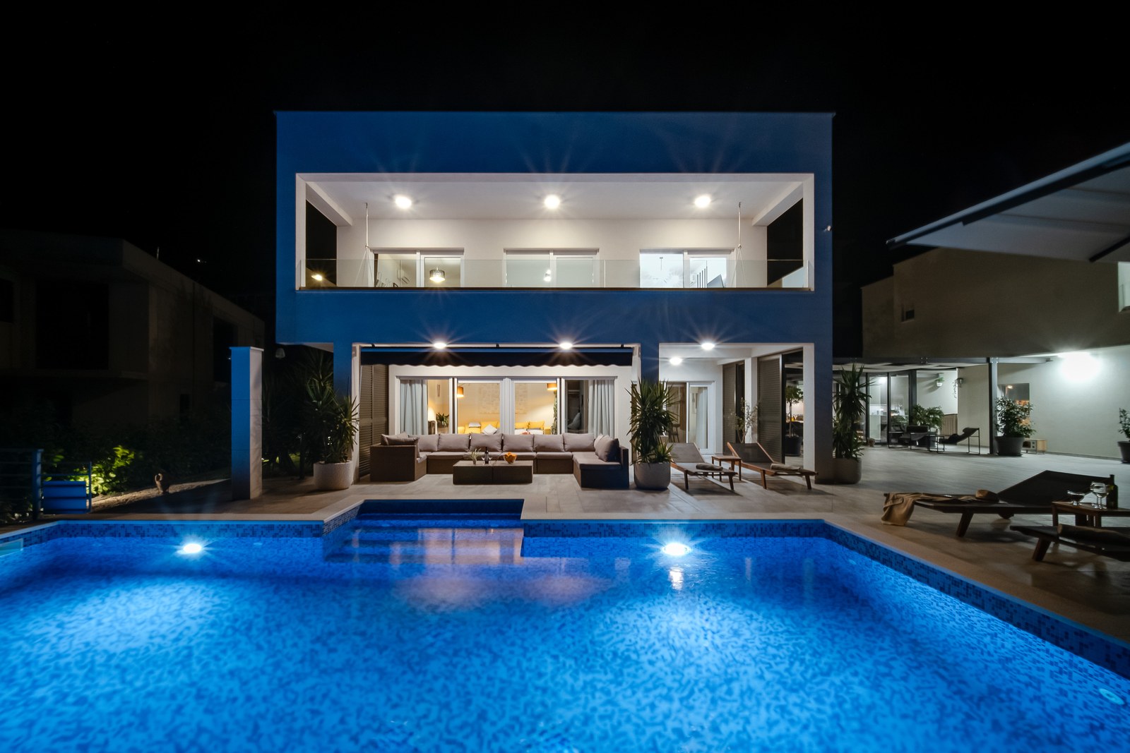 Villa BlueWave and its illuminated private swimming pool after dark