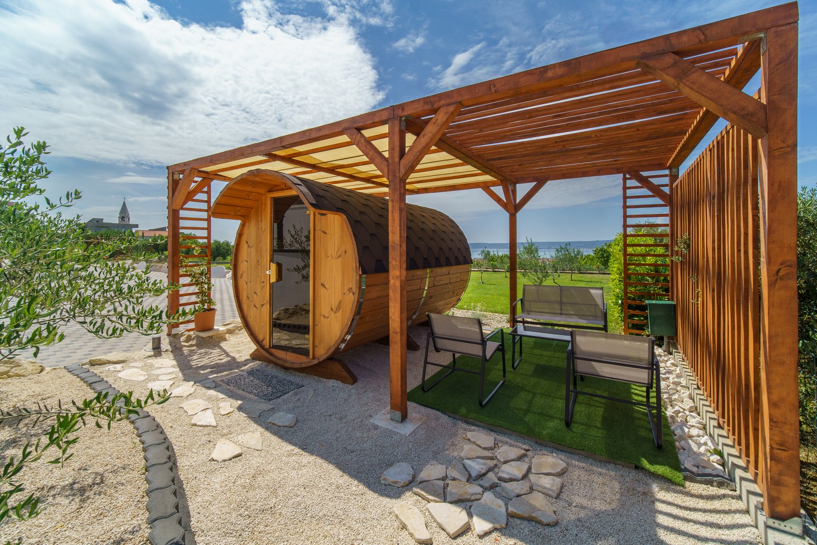 Private wooden barrel sauna in the Mediterranean garden at Villa BlueWave